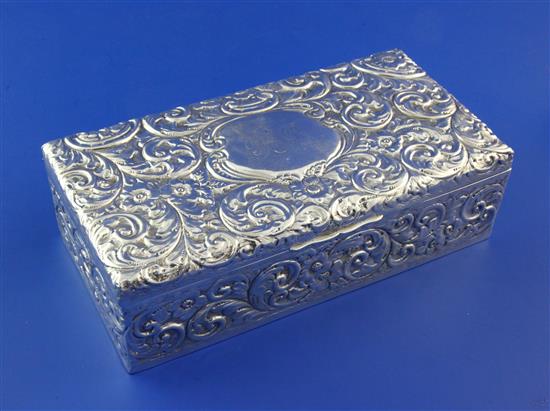 An Edwardian embossed silver rectangular cigarette box, 8.5in.